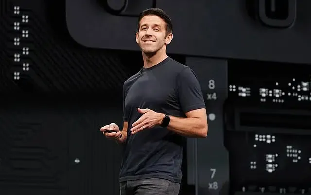 John Ternus presenting hardware engineering innovations during Apple corporate event